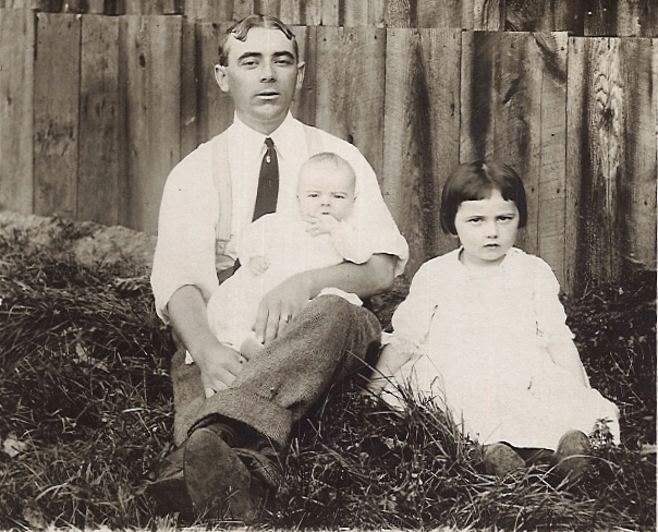 John W. Judge (1881 - 1972), holding his son Robert, with daughter Agnes sitting next to them.